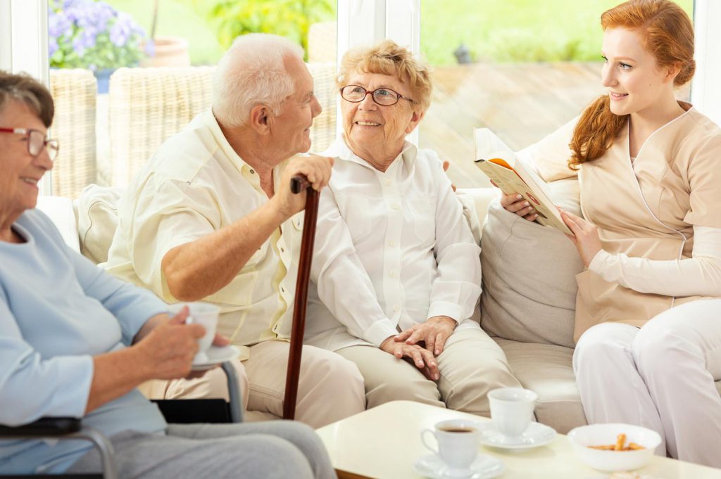 Group of seniors with caregiver in a home